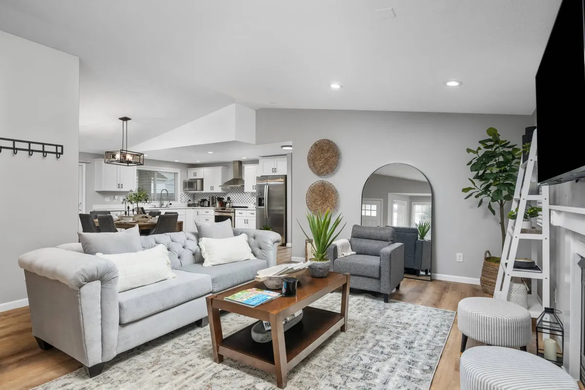 A cozy living area with a plush sofa, coffee table, and television set in an inviting environment perfect for relaxation and socializing after a day of work or travel.