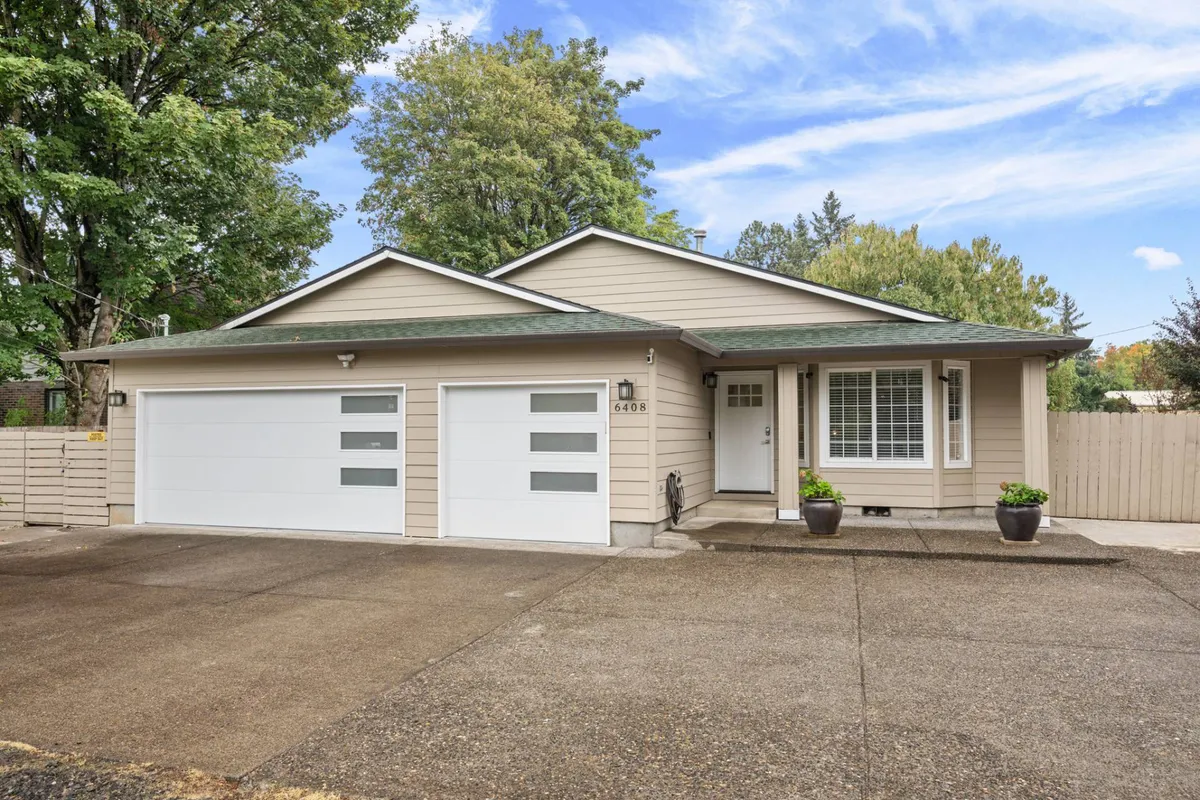 The image shows the front exterior of the home, featuring a two-car garage, a welcoming front door, landscaped entrance, and a window with shutters. Children are playing in the front yard while adults gather, hinting at a family-friendly atmosphere. The setting is lively and inviting, suggesting opportunities for outdoor fun right at home.